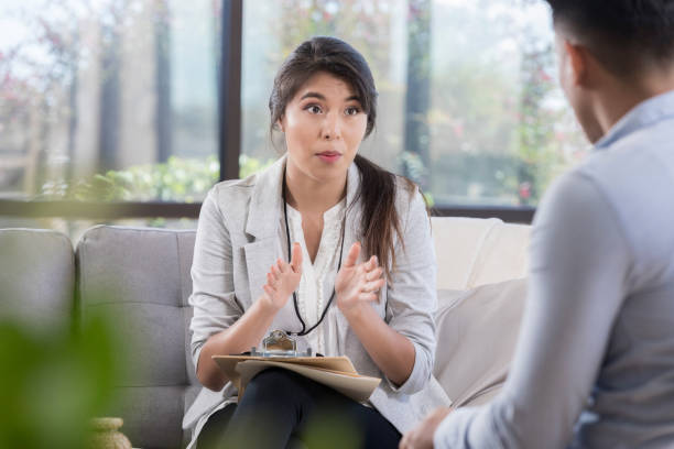 istock A young, female therapist talks and gestures to her patient 1070362374
