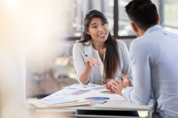 istock A young female gestures and talks with male 1070362398