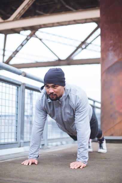 istock male exercising on a city bridge 1070362718