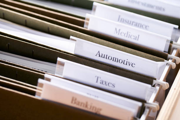 istock AUTOMOTIVE: Files and folders in desk drawer with labels and tabs: Home office management 1070363110