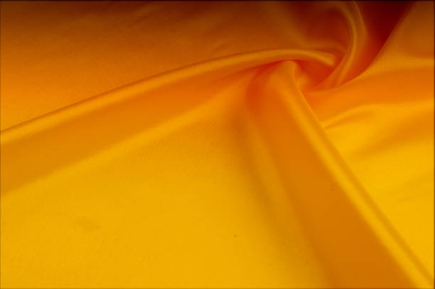 istock Texture, background, pattern. Red, yellow gold shades of silk fabric, text space. Gold satin texture, red silk background based on natural texture 1070366640