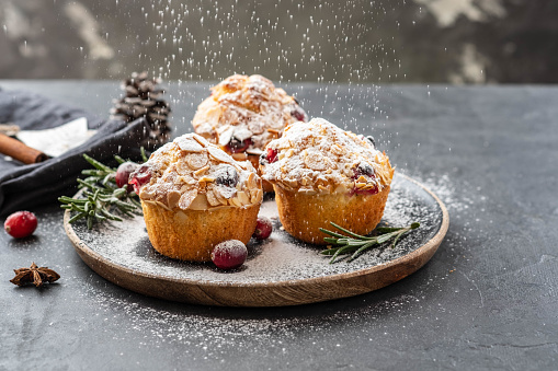 Muffins, cakes with cranberry and almond nuts. Christmas decoration. Close up.
