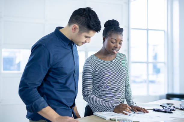 istock Design couple strategize in their modern studio 1070370684