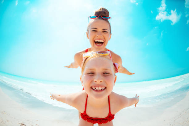 istock smiling young mother and child on seashore having fun time 1070372716