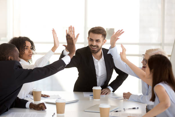 istock Excited diverse employees give high five celebrating success 1070375340