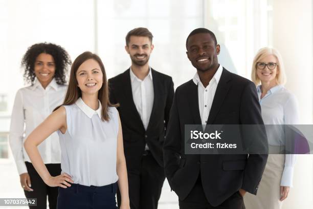 Portrait Of Smiling Diverse Work Team Standing Posing In Office Stock Photo - Download Image Now