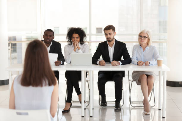 diverse recruiters listening to female applicant talk at interview - thinking professional occupation unemployment job search imagens e fotografias de stock