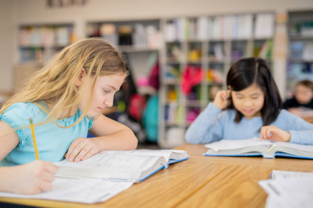 istock 4th grade girls studying in the classroom 1070377338