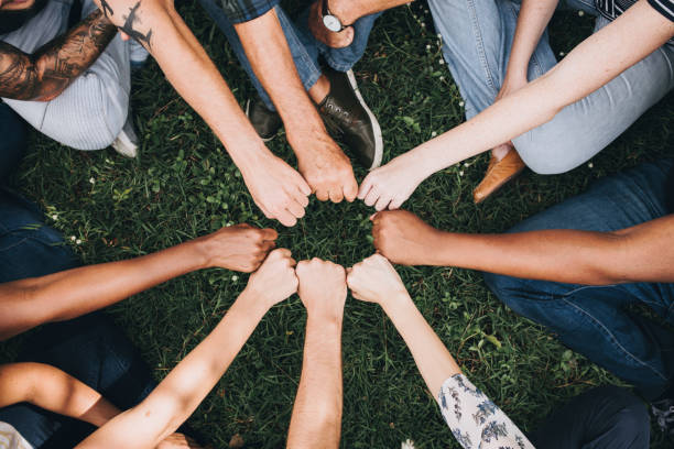 istock Diverse people doing a fist bump in the park 1070384066