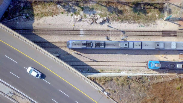 istock Modern passenger train leaving a train station - Top down aerial view 1070390276