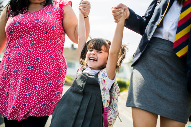 istock Mother and daughters on the way to school 1070392548