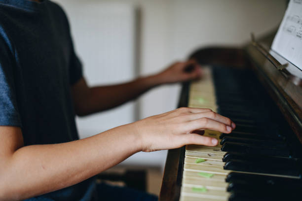 istock Young boy playing the piano 1070393304