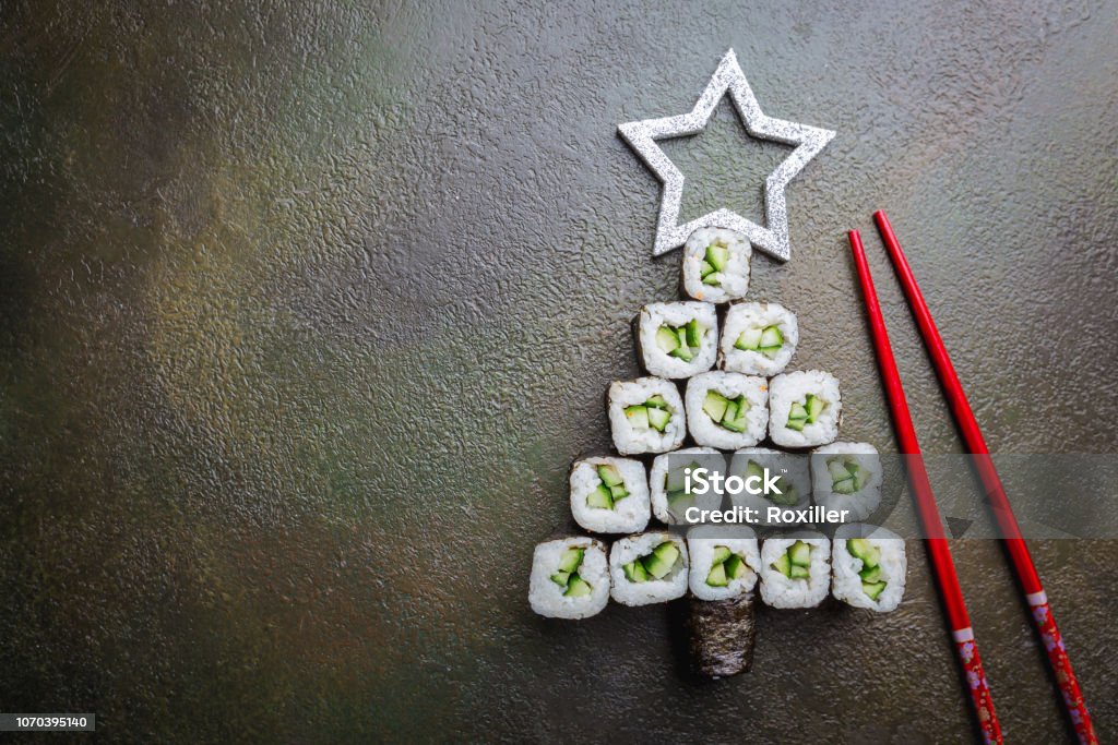 Sushi christmas tree Sushi christmas tree with star over dark background, top view with copy space. Christmas or New Year background Christmas Stock Photo