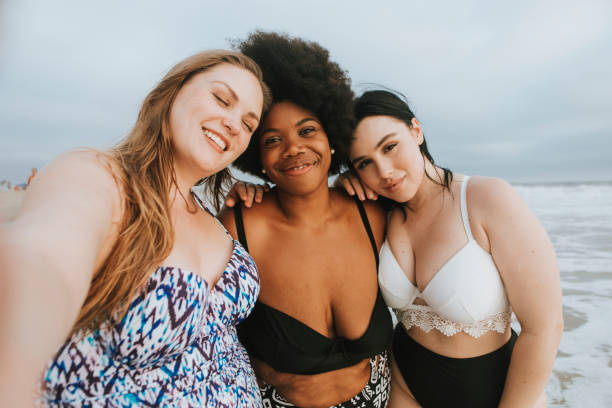 istock Beautiful curvy women taking a selfie at the beach 1070395224