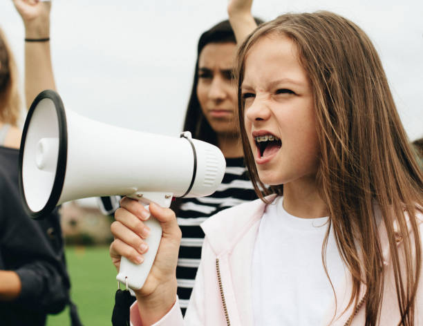 istock Female activist shouting on a megaphone 1070396034