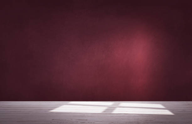 istock Burgundy red wall in an empty room with concrete floor 1070398338