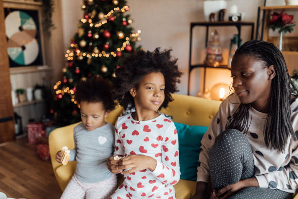istock Cute sisters eating Christmas breakfast 1070400316
