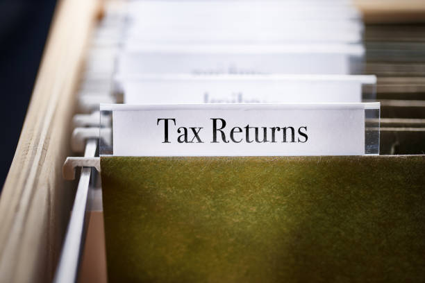 istock tax return: Files and folders in desk drawer with labels and tabs: Home office management 1070401018