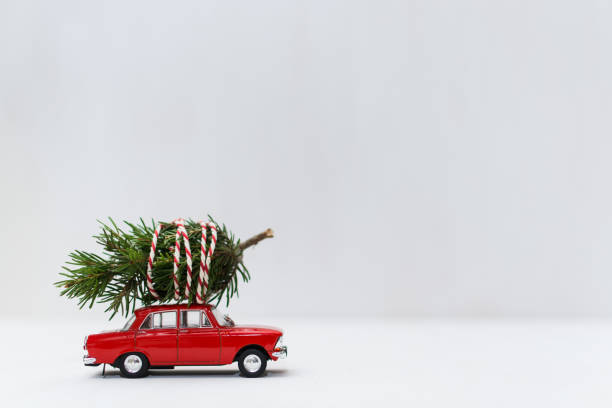 Red toy car with a christmas tree on the roof stock photo