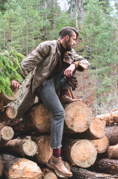 istock Young men on logs in the forest. Pine trees 1070412210