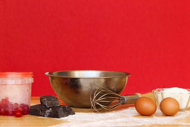 Baking or cooking background frame. Ingredients, kitchen items for baking cakes. Kitchen utensils, flour, eggs, candied cherry, chocolate, flour. Text space.