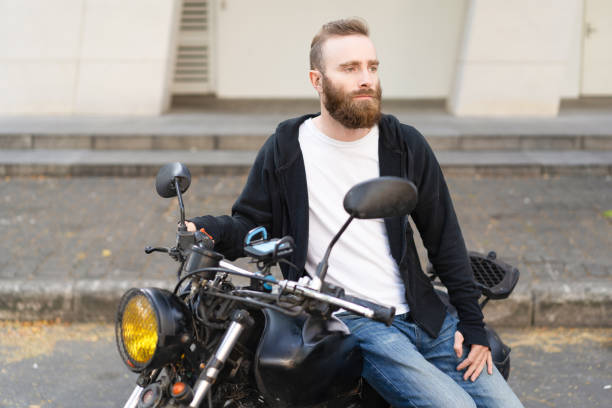 istock Pensive biker waiting girlfriend at parking space 1070418510