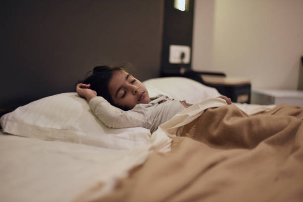 Young girl sleeping in the bed