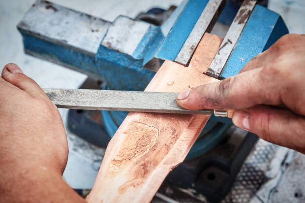 istock Grinding the copper billet with a file 1070434714
