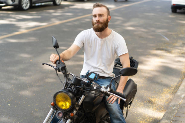 istock Pensive handsome biker posing with motorbike 1070439270