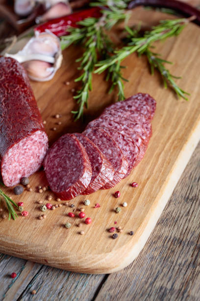 istock Smoked salami on a old wooden table. 1070440898