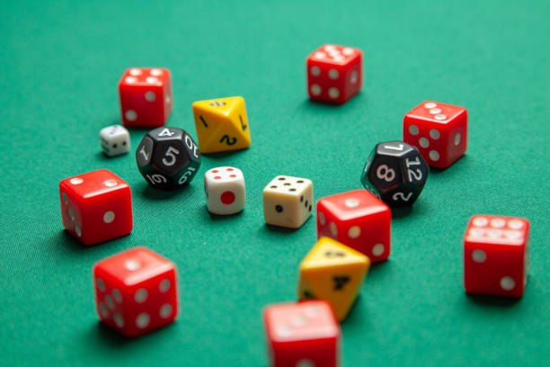 istock Collection of colored gaming dice cubes on green table 1070442544