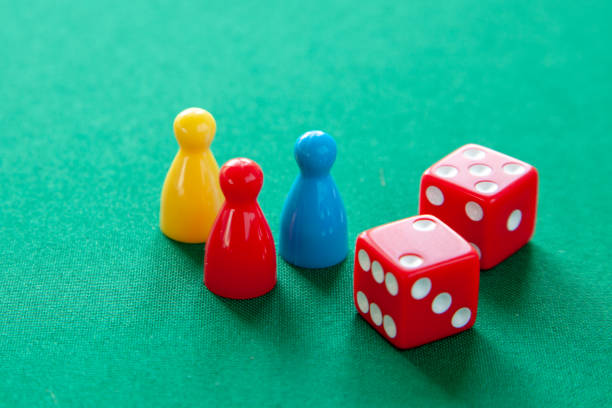 istock Colored game figures chips for board games. Collection of dice cubes on green table 1070445068