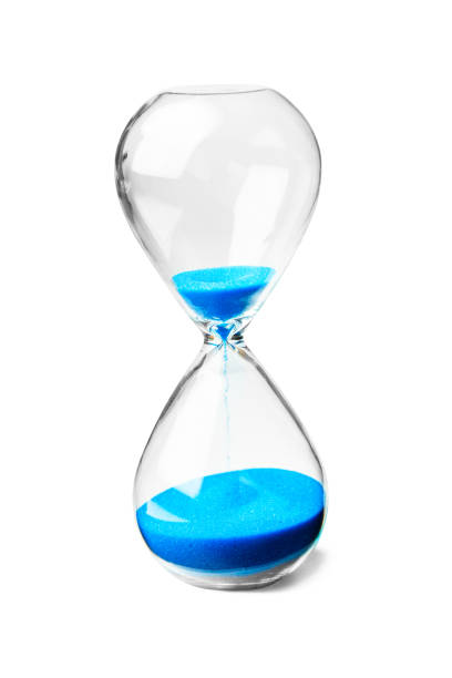 istock Glass hourglass with blue sand isolated on white background 1070445904