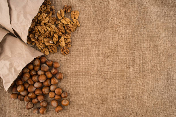 istock Walnuts and hazelnuts in the paper on the sacking. Top view. 1070446524