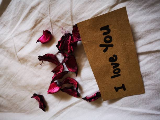 istock I Love You note on bed with flower 1070453028