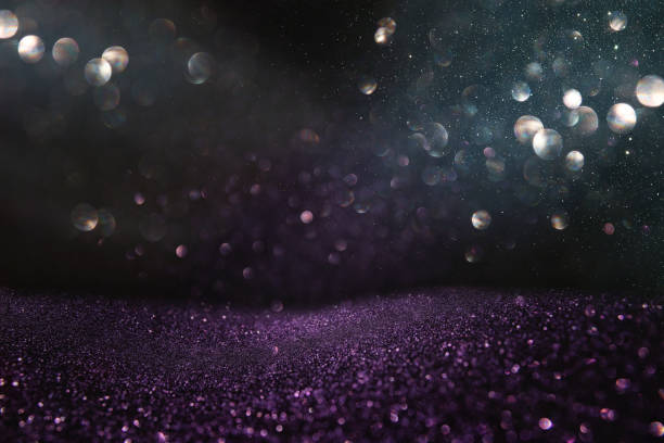 istock glitter vintage lights background. silver, black and purple. de-focused. 1070462668