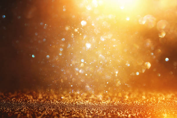 istock glitter vintage lights background. black and gold. de-focused. 1070462938