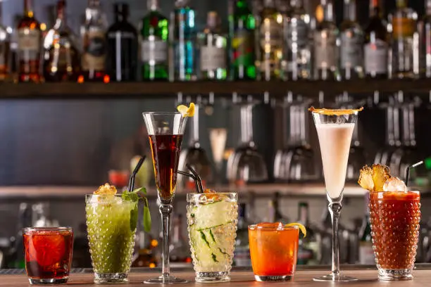 Photo of Alcohol bar, cocktail glass on bar counter, cocktail glass in a bar, Drinking cocktails