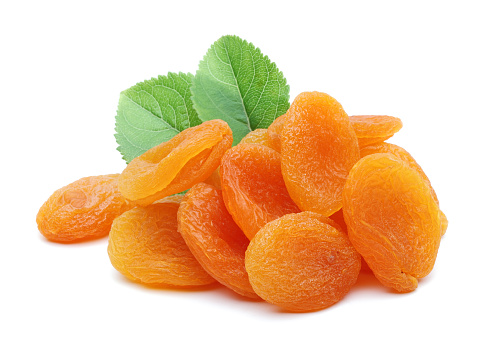 Dried apricots with leaves isolated on white background