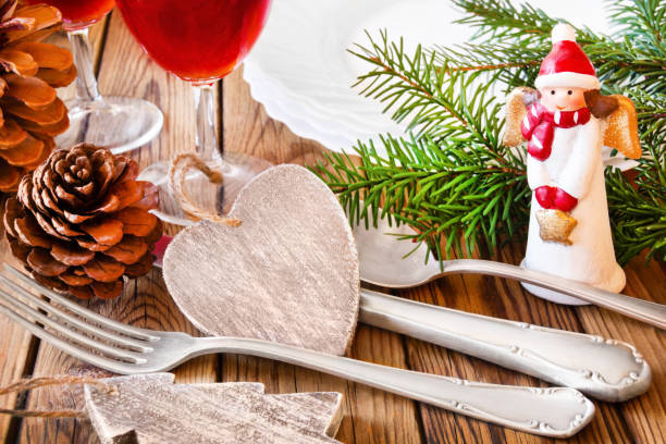 Christmas dinner table decoration with heart and angel