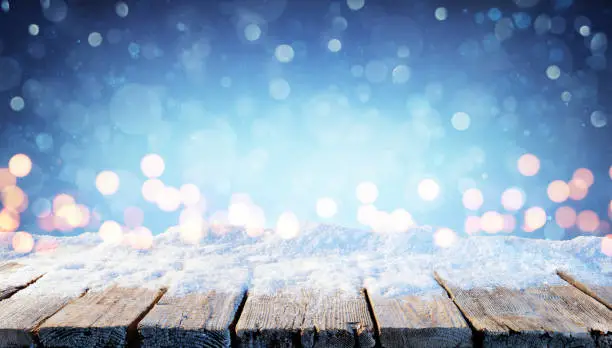 Holiday Background - Wooden Table With Snow And Bokeh In The Night