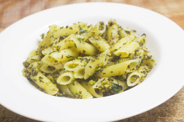 istock Penne pasta with pesto sauce 1070472192