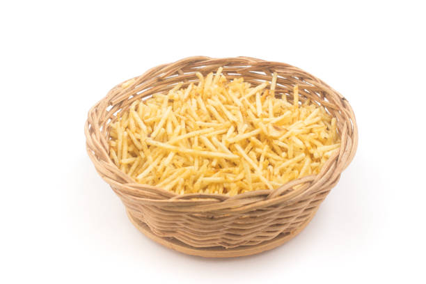Potato Sticks in a basket bowl. Batata Palha Potato Sticks in a basket bowl. Batata Palha isolated on white background batata stock pictures, royalty-free photos & images