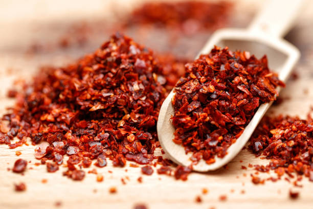 istock Dried ground red pepper in wooden scoop 1070472940