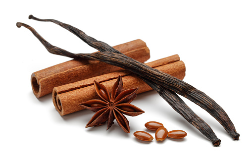 Vanilla pods, cinnamon sticks and star anise isolated on white background