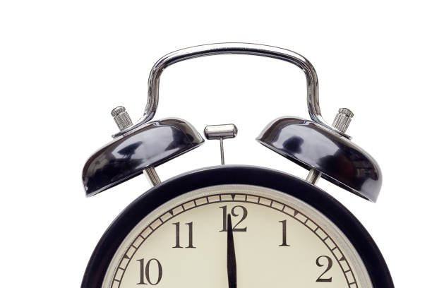 istock alarm clock with beige dial showing minute hand almost at twelve 1070478724