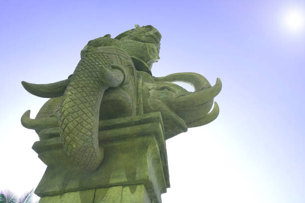 istock elephant stone sculpture in sky background and lens fare effect 1070484244