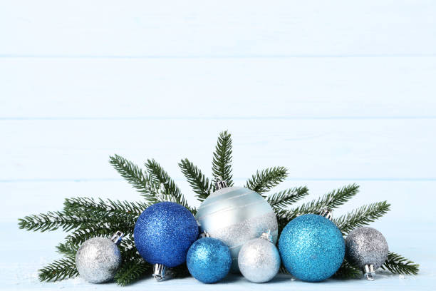 istock Christmas baubles with fir tree branches on wooden table 1070491784