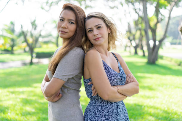 istock Content attractive multi-ethnic women standing back to back 1070492098
