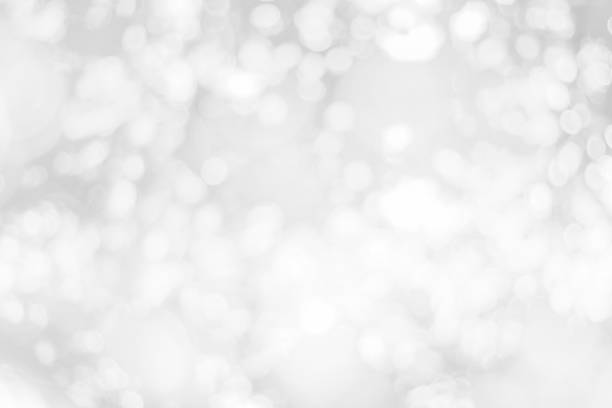istock Abstract glamorous white and silver bokeh lights glitter sparkle. Defocused background have luxury golden color party invite for birthday, anniversary, holliday, new year xmas or snow christmas blur. 1070497260